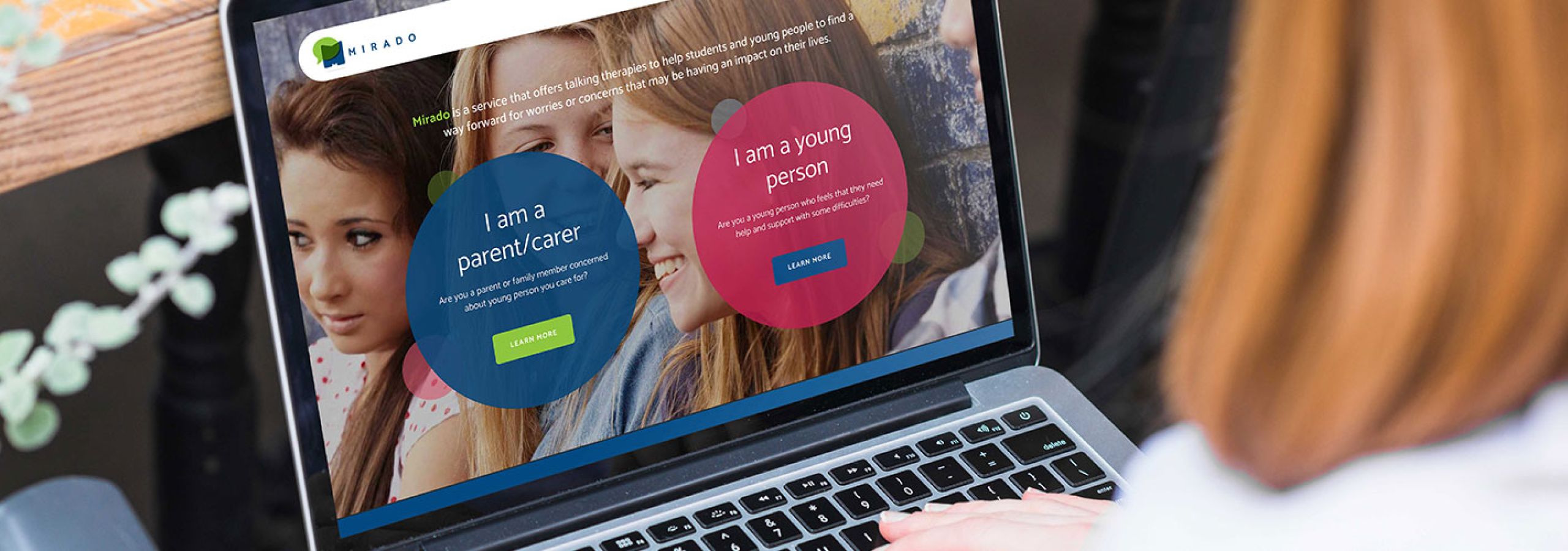 a person looking at the mirado website on a laptop