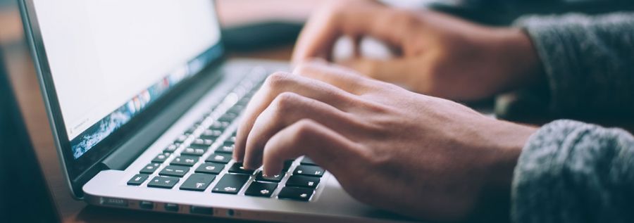 person typing on laptop